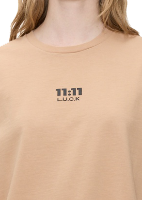 11:11 L.U.C.K logo on a beige t-shirt